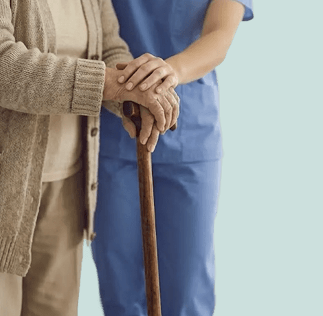 Nurse holding an elderly patient's hands